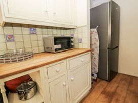 A kitchen with a microwave and refrigerator at White Stones Fulbrook, near Burford