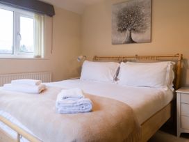 A bedroom with a bed and towels on it at White Stones, Fulbrook, near Burford
