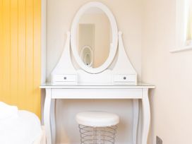 A vanity table with a mirror and stool at White Stones Fulbrook near Burford