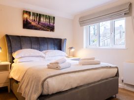 A bedroom with a bed and window at White Stones Fulbrook near Burford