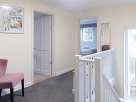 A hallway with a chair and doors at White Stones, Fulbrook, near Burford