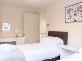 A bedroom with twin beds and a mirror at White Stones Fulbrook, near Burford