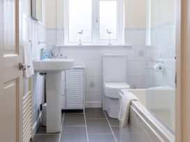 A bathroom with bathtub, sink, and toilet at White Stones Fulbrook, near Burford