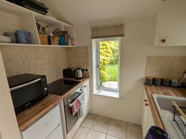 A kitchen with appliances and utensils at Little Pandy Cottage Afonwen near Caerwys