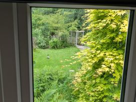 A view of a garden with grass and a duck at Little Pandy Cottage Afonwen near Caerwys