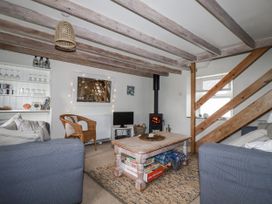 A living room with a fireplace and a coffee table at 3 The Green