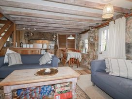 A living room with a sofa and table at 3 The Green