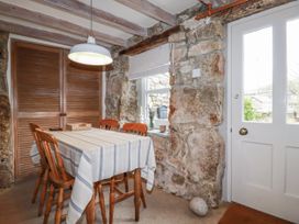 A dining room with a wooden table and chairs at 3 The Green