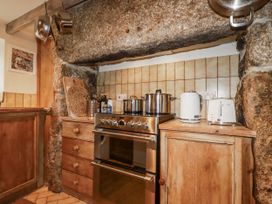 A kitchen with a stove and kettle at 3 The Green