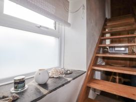 A staircase with a window and decorative items at 3 The Green
