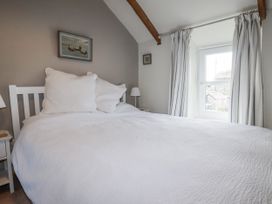 A bedroom with a bed and window at 3 The Green