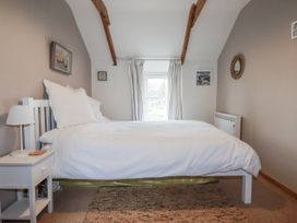 A bedroom with a bed and window at 3 The Green