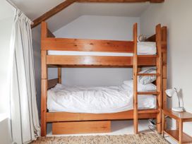 A bunk bed with mattresses in a bedroom at 3 The Green