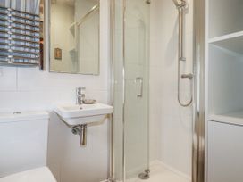 A bathroom with a shower, sink, and toilet at 3 The Green