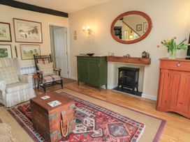 A living room with a table, cabinets, and artworks at 4 Duck Street in Dorchester
