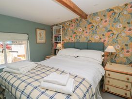A bedroom with a bed and bookshelf at 4 Duck Street, Dorchester