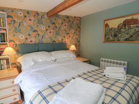 A bedroom with a bed and bookshelf at 4 Duck Street Dorchester