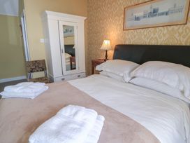 A bedroom with a bed and wardrobe at 4 Duck Street in Dorchester