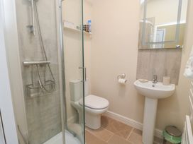 A bathroom with a shower, toilet, and sink at 4 Duck Street in Dorchester