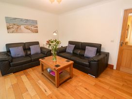 A living room with two sofas and a wooden coffee table at Cherry Tree House in Penzance