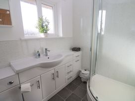 A bathroom with a wash basin and shower at Cherry Tree House in Penzance