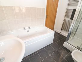 A bathroom with a bath and shower at Cherry Tree House in Penzance