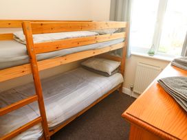 A bedroom with a bunk bed and a dresser at Cherry Tree House in Penzance