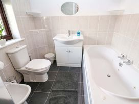 A bathroom with a sink, toilet and bathtub at Cherry Tree House in Penzance