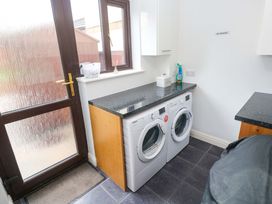 A laundry room with a washing machine and dryer at Cherry Tree House in Penzance