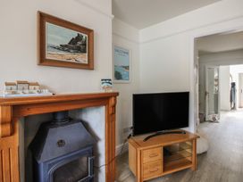 A living room with a television and a fireplace at Home in Salcombe