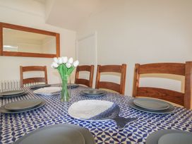 A dining room with a table set for a meal at Home in Salcombe