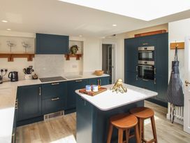 A kitchen with a stove, oven, and sink at Home in Salcombe
