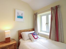 A bedroom with a bed and window at Home in Salcombe