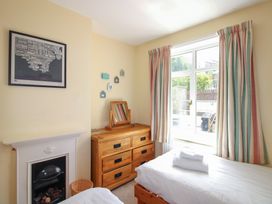 A bedroom with a bed and a dresser at Home in Salcombe