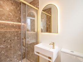 A bathroom with a shower and a wash basin at Home in Salcombe