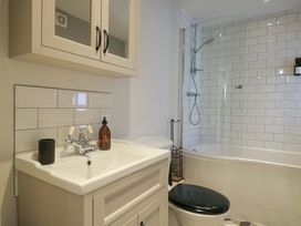 A bathroom with a sink, shower, bathtub and toilet at The Tap Room in Kingham