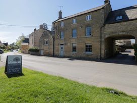A building exterior featuring a sign at The Kinham Plough in Kingham