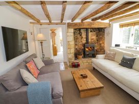 A living room with a sofa and fireplace at Wyncliffe in Chipping Campden