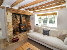 A living room with a fireplace and sofa at Wyncliffe in Chipping Campden