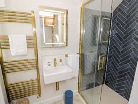 A bathroom with a shower, sink, and towel rack at Wyncliffe in Chipping Campden