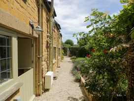 A pathway beside a house with plants and a door at Wyncliffe in Chipping Campden