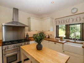 A kitchen with a stove and sink at Bell Garden, Stow-On-The-Wold