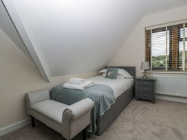 A bedroom with a single bed and a chair at Bell Garden Stow-On-The-Wold