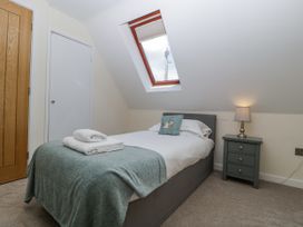 A bedroom with a bed and nightstand at Bell Garden, Stow-On-The-Wold