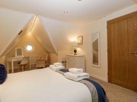 A bedroom with a bed and desk at Bell Garden in Stow-On-The-Wold