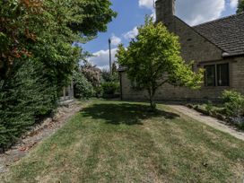 A garden with a house, tree and bushes at Bell Garden in Stow-On-The-Wold