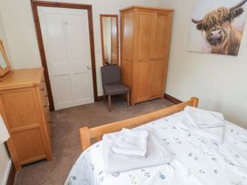 A bedroom with furniture including a bed and wardrobe at The Old Dairy in Maenclochog