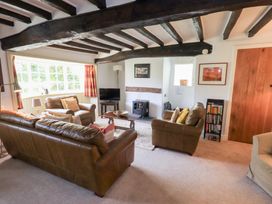 A living room with sofas and a coffee table at Burnside Cottage in Braithwaite