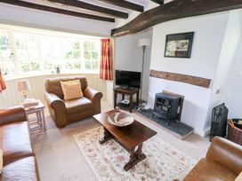 A living room with a tv and a coffee table at Burnside Cottage in Braithwaite