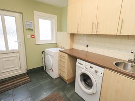 A laundry room with a washing machine and sink at Hazelmere in Keswick